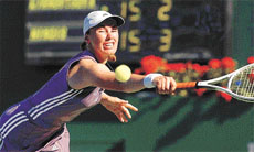 Martina Hingis of Switzerland returns a shot 