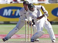 South Africa's Paul Adams gets the ball away for a six