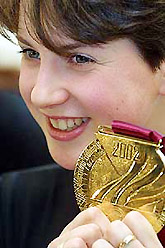 Russian figure skater Irina Slutskaya poses with a medal made of over 700 grams of pure gold 