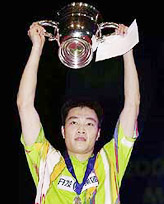 Chen Hong of China holds aloft his winner's cup after winning the men's singles final match at the All-England Open Badminton Championships