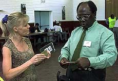 Harare resident Cheryllynn Watson (left) argues with an electoral official