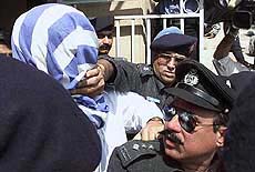 A Pakistani police officer silences Sheikh Omar 