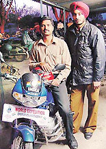 Harinder Singh Flora and Harjinder Singh, residents of Hoshiarpur, in Chandigarh on Wednesday as part of their world tour on motorcycle.