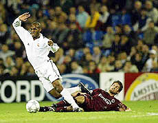 Real Madrid's Geremi falls after a tackle 