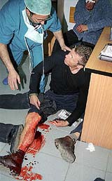 Freelance photojournalist Hubert Picard gets first aid after he was wounded during exchange of fire between the Israeli army and Palestinian gunmen