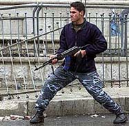 A Palestinian gunman takes up a shooting position