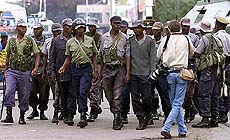 The Zimbabwe riot police is photographed while they watch supporters of the ruling party