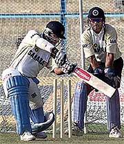 India�s captain Saurav Ganguly (L) drives a ball as teammate Rahul Dravid stands by during a net-practise session on the eve of the fourth one-day International between India and Zimbabwe at the Lal Bahadur Shastri stadium in Hyderabad, on Friday.