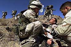 US Army medic Specialist Johnny Agbi (L) treats Sergeant Chadd Lindsay