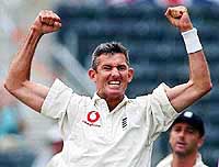 Kiwi born English bowler Andrew Caddick celebrates the wicket of Mark Richardson 