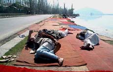 Three Kashmiri elders sleeping at the bank of the famous Dal Lake 