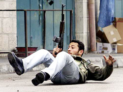 A Palestinian gunman exchanges fire with Israeli troops 
