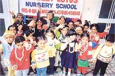 Tiny tots of Lovely Lotus Nursery School say goodbye to their teachers at a farewell party in Ludhiana on Tuesday.