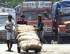 Labourers push a cart