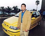 Cricket star Sachin Tendulkar poses in front of Italian car maker Fiat's new "Palio S 10" hatchback in Mumbai on Tuesday during the car's domestic launch.