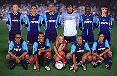 US pop star Britney Spears appears in a handout promotional photo with a team of international soccer stars 