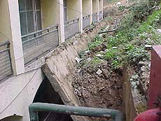 A recently constructed retaining wall collapses at the back of the HP Government Secretariat �Armsdale� building on Wednesday.
