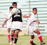 Players of Indian Nationals (in black and white ) and the Assam Electricity Board (in white) battling it out for supremacy in the 2nd Division NFL at the Ambedkar Stadium in the Capital