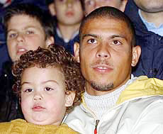 Brazilian soccer ace Ronaldo and his son Ronald watch a friendly women�s soccer match between Fiammamonza and a selection of players of the U.S. national team from the stands of the Brianteo Stadium in Monza, northern Italy on Tuesday. 