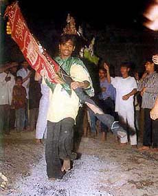 Devout Muslim performs "aag ka matam" during the observance of Moharrum 