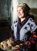 A 51-year-old mother of 11 holds a dish with bread