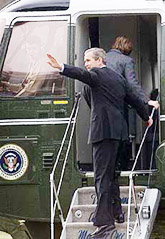 US President George W. Bush waves to guests as he boards Marine One 