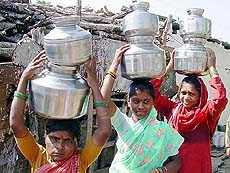 Women carry pots of water