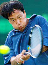 Michael Chang of the USA backhands a return to Paradorn Srichaphan of Thailand