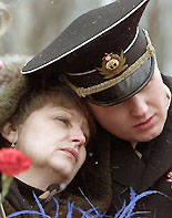 Irina Lyachin (L), wife of Russian submarine Kursk commander Gennady Lyachin, and his son Gleb, grieve 