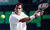 Pete Sampras of the US backhands a return