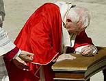 Pope John Paul II kneels to pray 