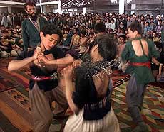 Afghan Shi'ite boys beat themselves on the back with chains during the observance of Ashoura
