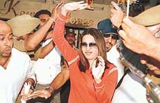 Cornered: Karisma Kapoor fights for a comfortable slot in a store in Sector 9, Chandigarh, even as crazy fans shower adoration upon her on Monday.