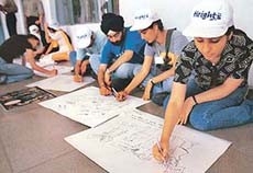 Students participate in the cartoon-making competition at the Cyanide-2002 at Panjab University in Chandigarh on Monday. 