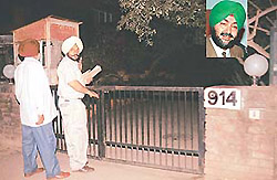 Officials of the Punjab Vigilance Bureau at the residence of the PPSC Chairman in Sector 39, Chandigarh on Monday. Inset: R. S. Sidhu.