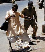 A policeman helps a blind person