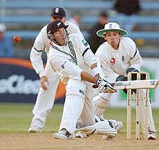 New Zealand batsman Craig McMillan plays a shot, watched by England's Nasser Hussain and James Foster, on the fifth and final day of the second Test in Wellington on Monday. 