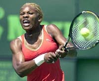 Serena Williams returns a shot from Katarina Srebotnik