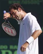 Pete Sampras of the USA wipes his brow after losing a point to Fernando Gonzalez 