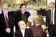 Palestinian leader Yasser Arafat, second right standing, and members of the International Parliament of Writers