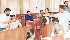 Mr Gian Chand Gupta of the Bharatiya Janata Party and Mr Pradeep Chhabra of the Congress argue over a point in the Municipal Corporation House, Chandigarh, on Wednesday.