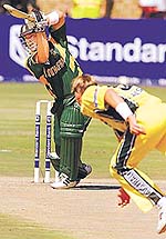 Brett Lee follows through as Herschelle Gibbs drives the ball during the third one-day international between Australia and South Africa in Potchefstroom on Wednesday.