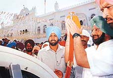 Punjab Chief Minister Amarinder Singh acknowledges the greetings after receiving a siropa