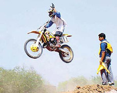 Revat Dhillon waves after completing the last hurdle in the Servo Super Cross held at Circus Grounds, Sector 17, Chandigarh, on Sunday.