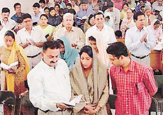 Devotees take part in Easter prayer in the Baptist Church, Sector 44-C, Chandigarh, on Sunday.