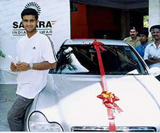 Sourav Ganguly stands beside the new Mercedes Benz