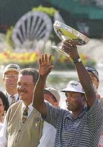 Vijay Singh waves to the gallery as he lifts the Shell Houston Open trophy