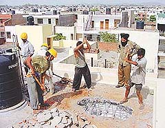 A demolition squad of the Chandigarh Housing Board at work