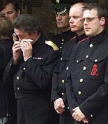 The Queen Mother's butler Billy Tallon wipes his face