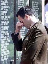 Argentine Army Major Fabian Vazquez is overcome with grief while visiting the memorial wall 